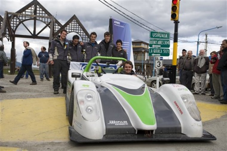 Alexander Schey sits in the SRZero electric sports car as other staff members of the British eco-adventure Racing Green Endurance team stand behind in Ushuaia, Argentina, on Tuesday.